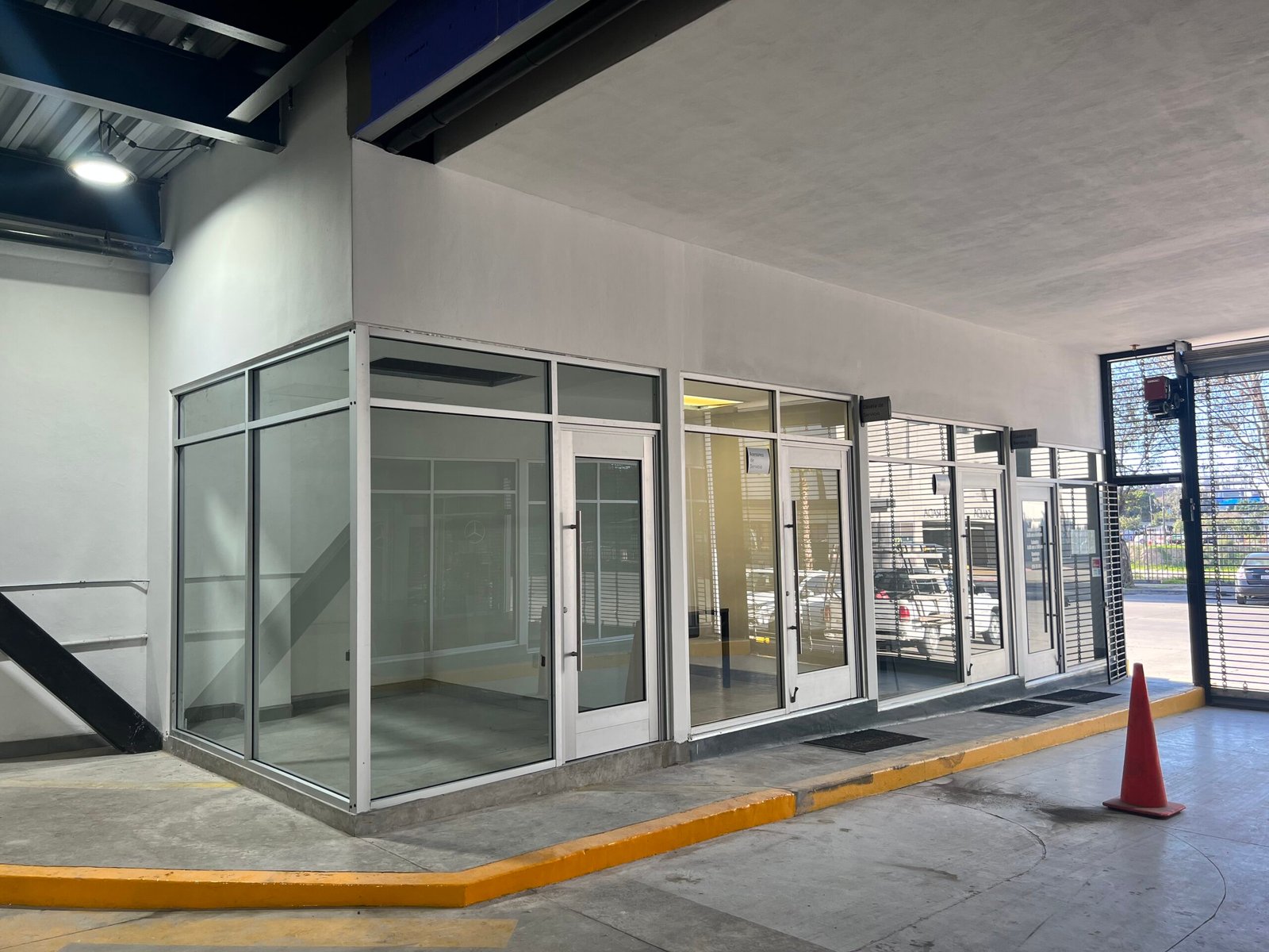 Vista exterior de oficina en esquina con cancelería de vidrio templado en Mercedes Benz Tijuana
